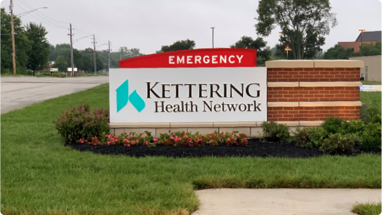 Kettering Health Network roadside sign placed in landscaped area