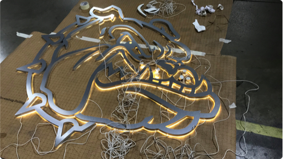Lights being assembled in shape of bulldog head to create LED light